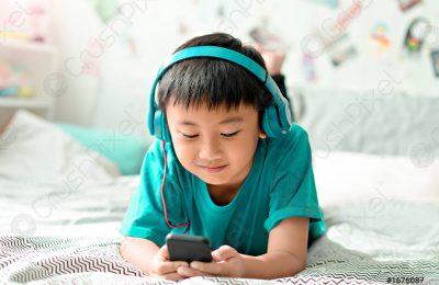 kid-listening-music-on-bed-1676087