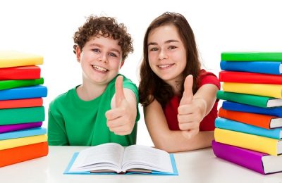 Girl and boy between piles of book isolated on white